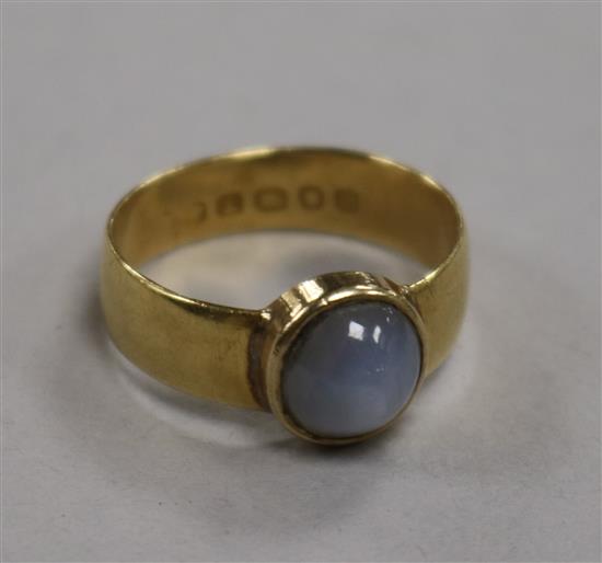 An 18ct gold and cabochon star sapphire ring, collet-set, size O.